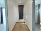 Bright and neatly designed hallway with wood flooring