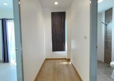 Bright and neatly designed hallway with wood flooring