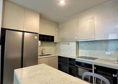 Modern kitchen with white cabinetry and marble countertops