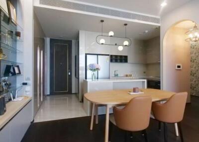 Modern kitchen with integrated dining area and stylish lighting