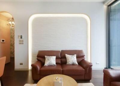 Modern living room with leather sofa and stylish lighting