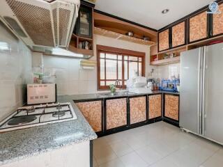 Spacious and well-equipped kitchen with modern appliances and ample storage