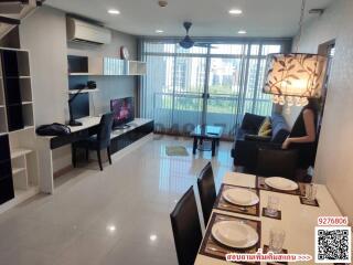 Spacious and well-lit living room with modern furniture and balcony view