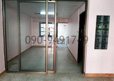 Spacious hallway with glass partitions and artistic wall tiles
