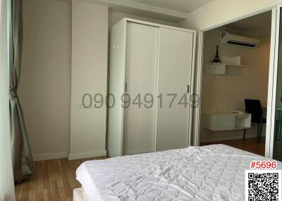 Spacious bedroom with large wardrobe and desk area