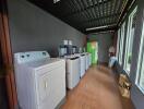 Spacious laundry room with modern appliances and ample natural light