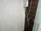 Compact bathroom with wall-mounted shower and dark wooden flooring