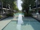 Swimming pool surrounded by residential buildings with lush green trees