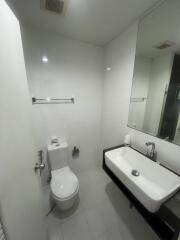 Modern white bathroom with wall-mounted toilet and sink