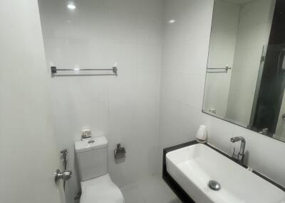 Modern white bathroom with wall-mounted toilet and sink