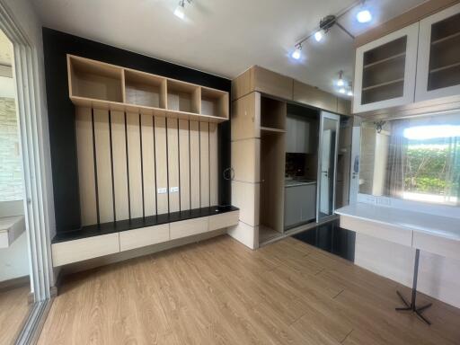 Spacious and modern living room with wooden flooring and stylish built-in shelving units