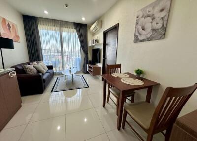 Spacious and well-lit living room with dining area