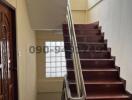 Interior staircase with wooden steps and modern handrails
