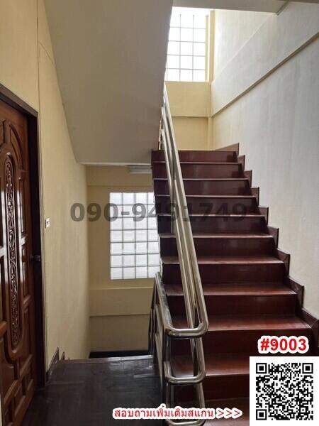 Interior staircase with wooden steps and modern handrails