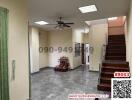 Spacious living room with staircase and tiled flooring