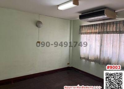 Spacious empty bedroom with air conditioner and large window