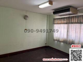 Spacious empty bedroom with air conditioner and large window