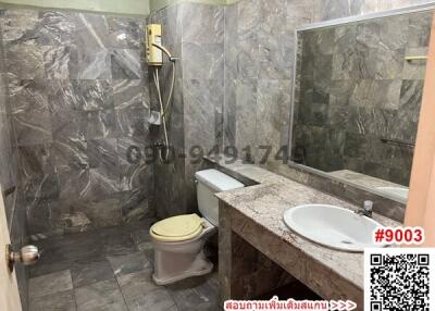Spacious marble-finished bathroom with modern facilities