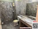 Spacious marble-finished bathroom with modern facilities