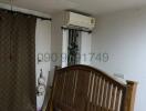 Spacious bedroom with wooden bed and air conditioning unit