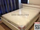 Spacious bedroom with large double bed and white bedframe