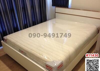 Spacious bedroom with large double bed and white bedframe