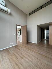 Spacious and modern living room with wooden flooring and minimalist decor