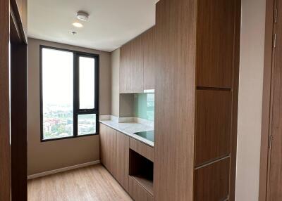 Spacious and well-lit living room with wooden flooring and built-in storage