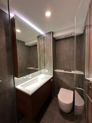 Modern bathroom with reflective surfaces and elegant fixtures