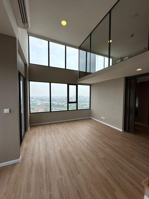 Spacious modern living room with large windows and city view