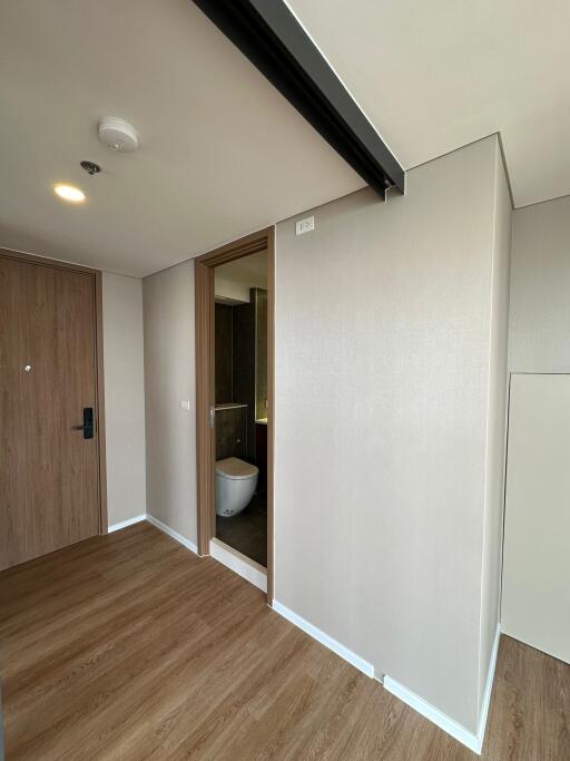 Modern hallway with wooden flooring leading to bathroom