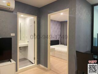 Modern bedroom with attached bathroom and mirrored wardrobe