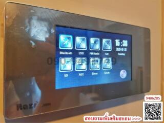 Modern wall-mounted control panel with various functions including Bluetooth, USB, FM Radio, and more