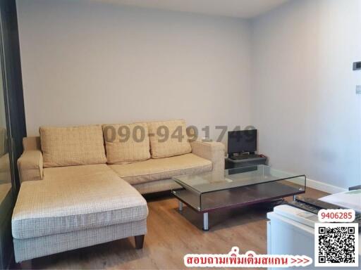 Spacious and well-lit living room with a large sofa and a coffee table