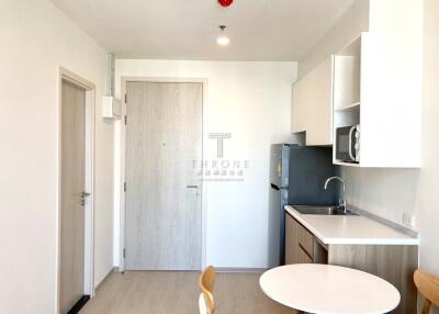 Modern apartment kitchen with white interiors and minimalist design