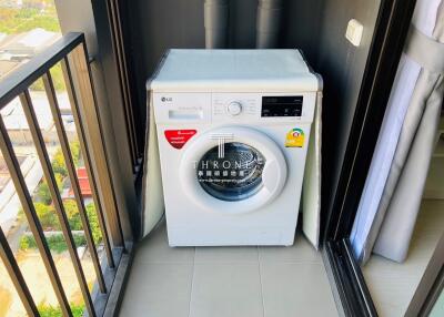 Washing machine placed on apartment balcony with city view