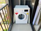 Washing machine placed on apartment balcony with city view