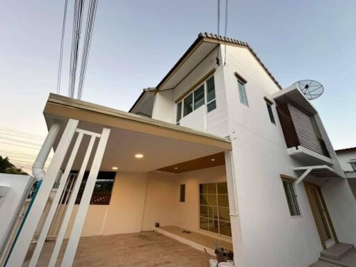 Modern two-story house exterior with spacious garage and balcony