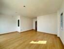 Spacious and bright empty living room with hardwood floors