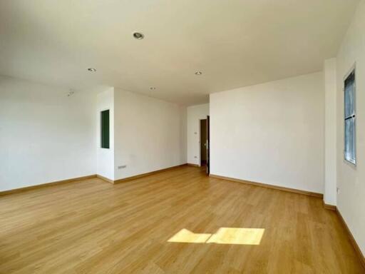 Spacious and bright empty living room with hardwood floors