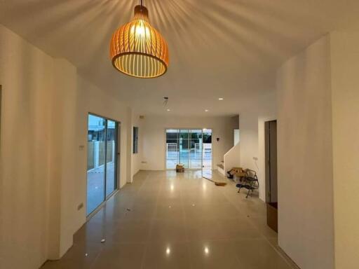 Spacious living room with modern lighting and tiled flooring