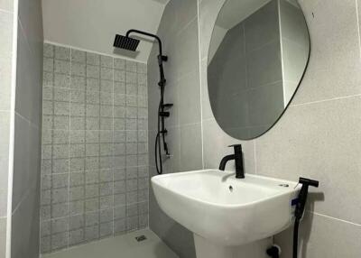 Modern compact bathroom with shower and wall-mounted sink