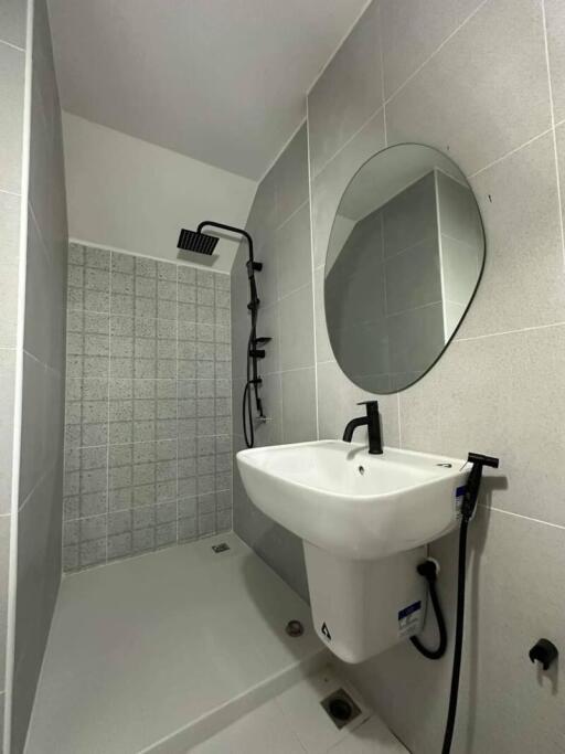 Modern compact bathroom with shower and wall-mounted sink