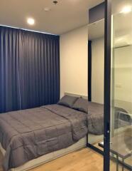 Modern bedroom with large window and glass wall