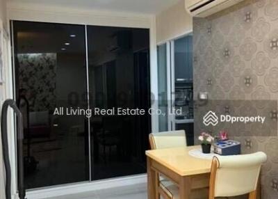 Well-lit living room with modern decor and balcony access