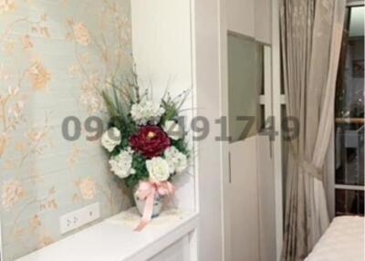 Elegant bedroom with floral wallpaper and modern amenities
