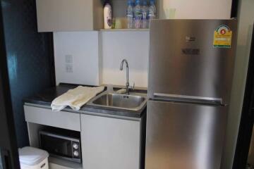 Modern compact kitchen with stainless steel appliances