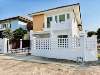 Modern two-story house with white and wooden facade