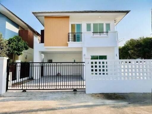 Modern two-story residential house with gated entrance
