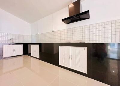Modern kitchen with white cabinetry and glossy floor tiles